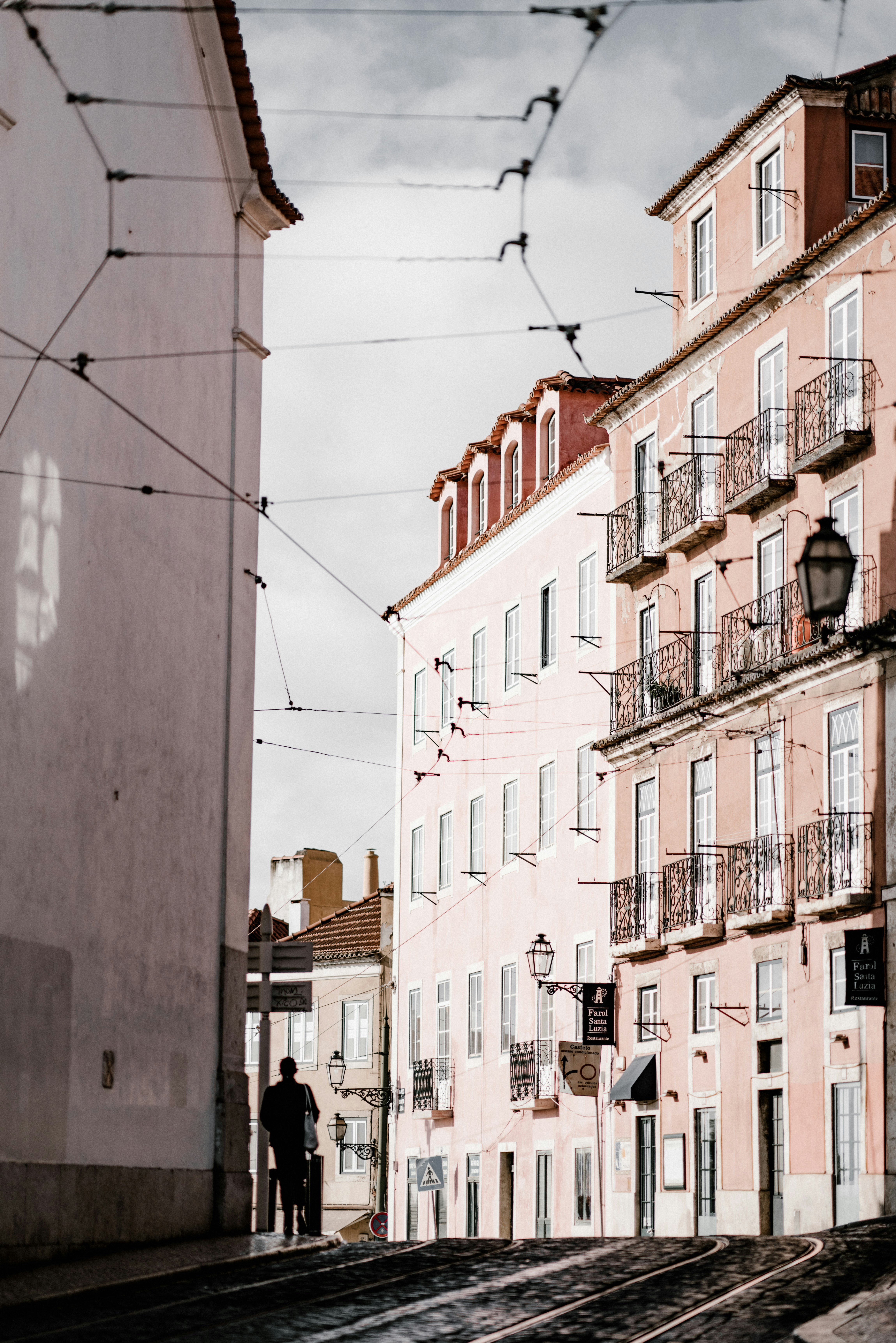 man standing beside building at daytime